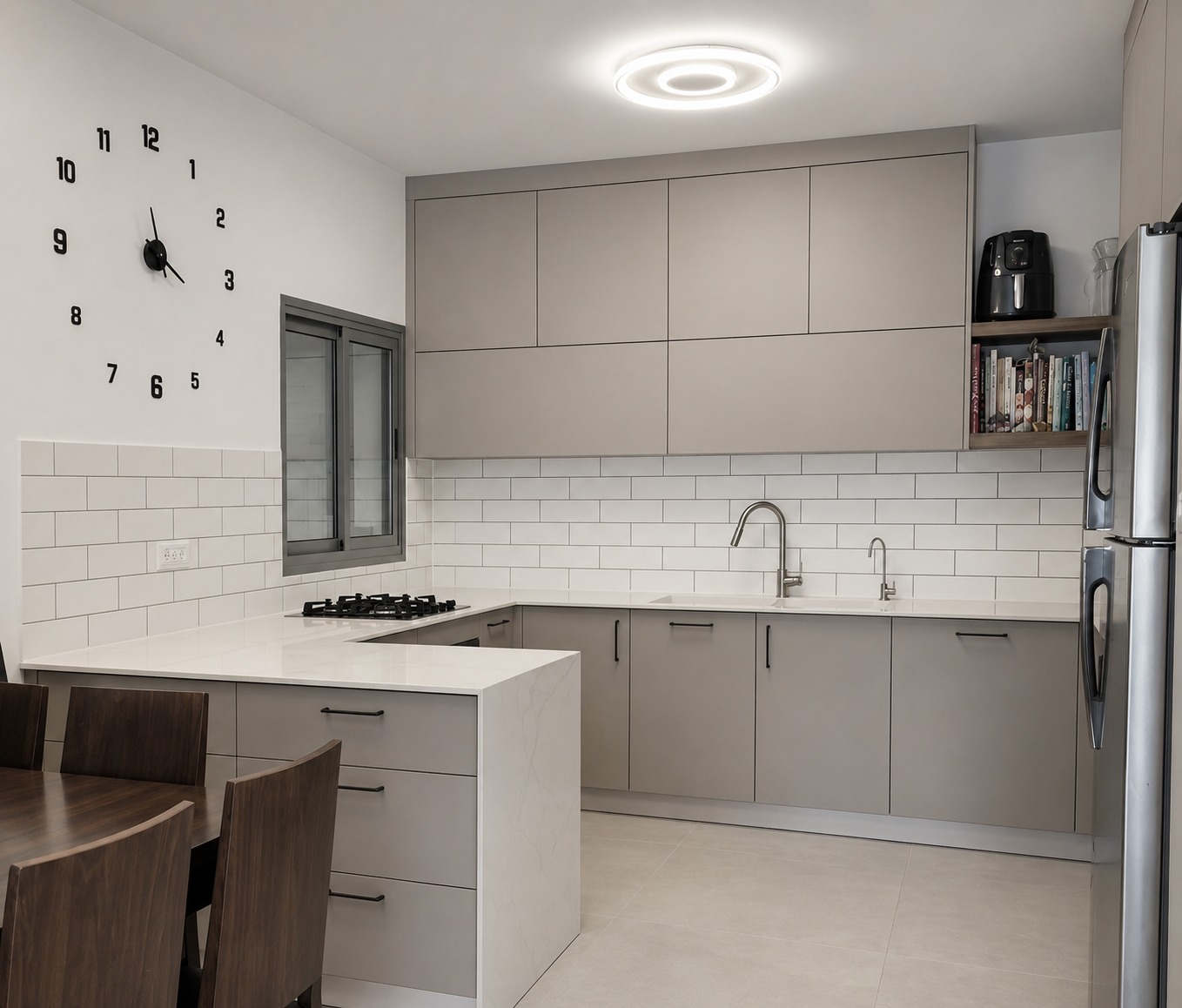 Greige U-shaped kitchen with white subway tile and a waterfall stone peninsula